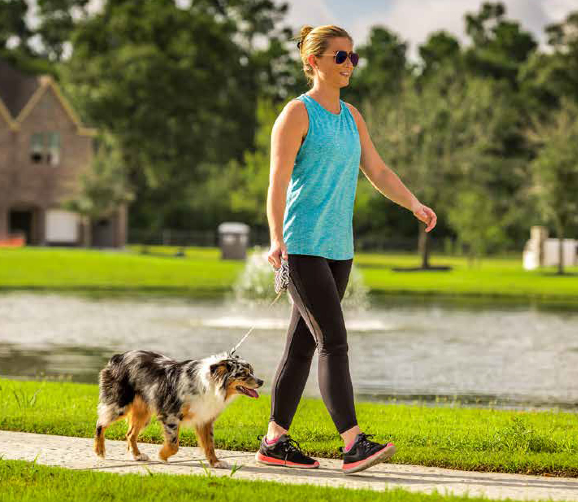 Resident walking a dog along the lake in a Caldwell community