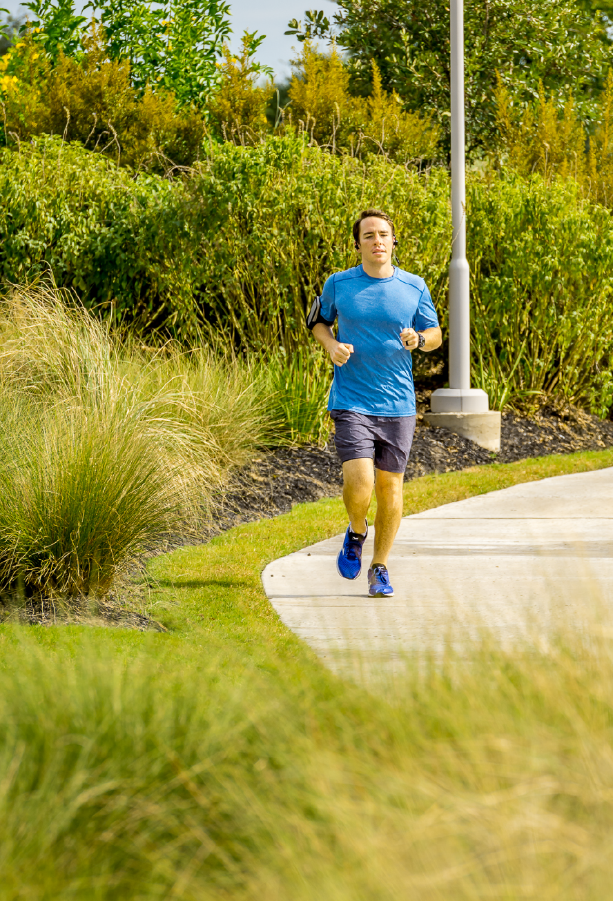 Resident jogging along community trail